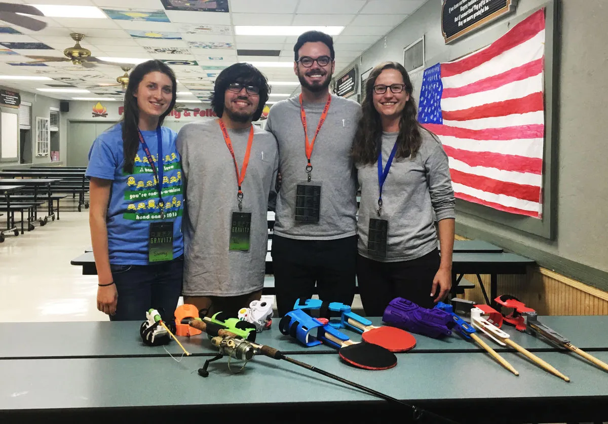 Martin Vassolo / Alligator - Members of UF GRiP, a club that 3-D prints activity-specific prosthetics, pose with some of their newer models at Hand Camp 2017, a gathering of children with limb differences held from Friday to Sunday in Starke, Florida.